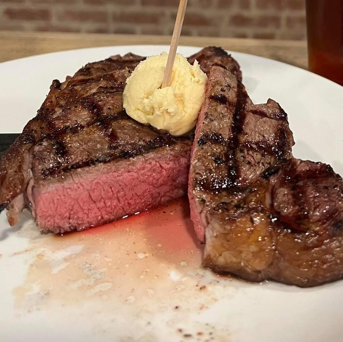 Hand-cut ribeye grilled to order with herb butter at The South Street Grille